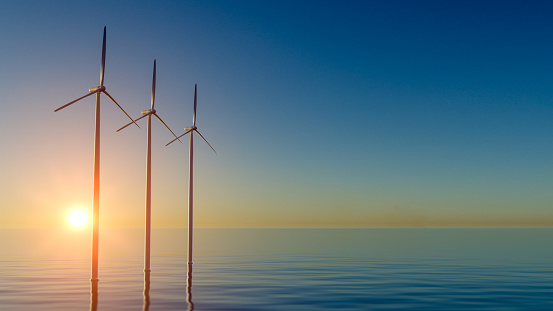 Offshore Wind Turbines Farm At sunset. Green ecological power energy generation. Floating wind turbines installed in sea. Alternative energy source