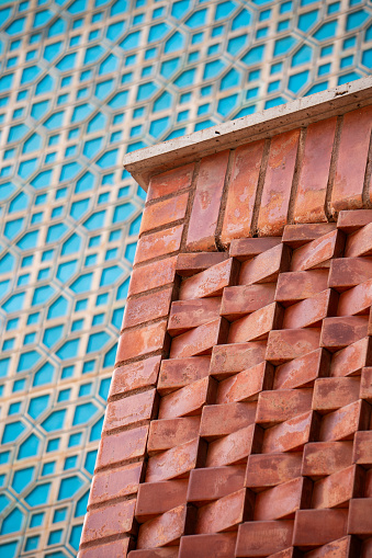 The pattern of the brown and blue carved wall of the Iranian mosque.