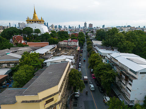 The Golden Mount buddhist temple in Bangkok city with office building background aerial view Thailand