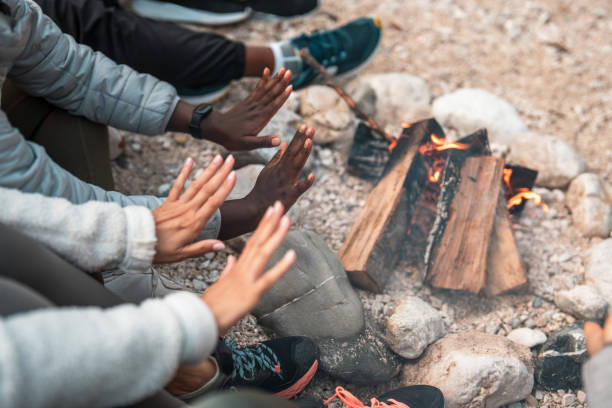 istock Multi-Ethnic Friends Warming up Their Hands in Front of A Bonfire 1952026673