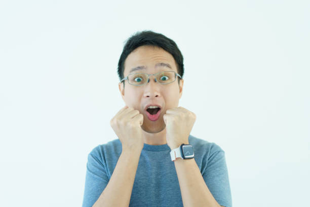 Happy Asian good looking - handsome man portrait, age between 30 - 35 years old. Close up on upper body of a good looking Asian middle adult male laughing and smile to camera. Delightful man portrait close up.