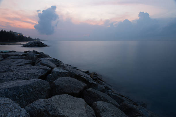 istock A stone dam breaks up the ocean waves in the morning. 1952037314