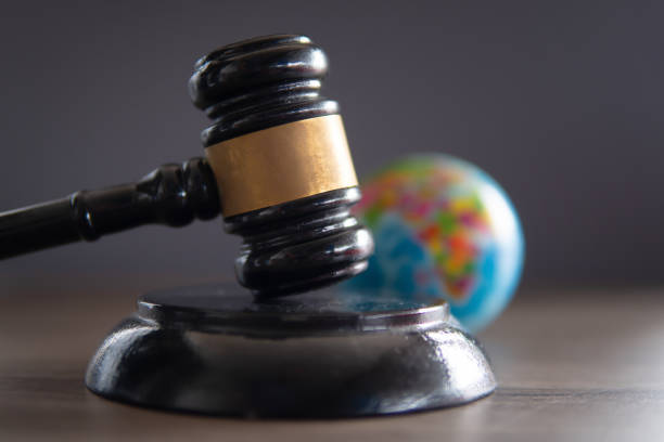 istock Closeup image of judge gavel and world globe on table. 1952037851
