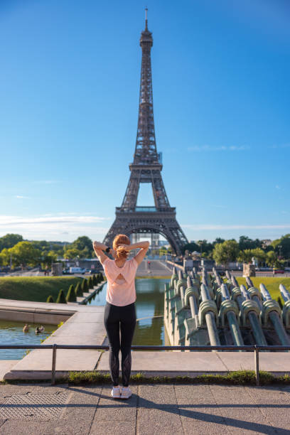 istock Rear view on woman taking up outdoor exercise, stretching on Paris Waterfront 1952042164