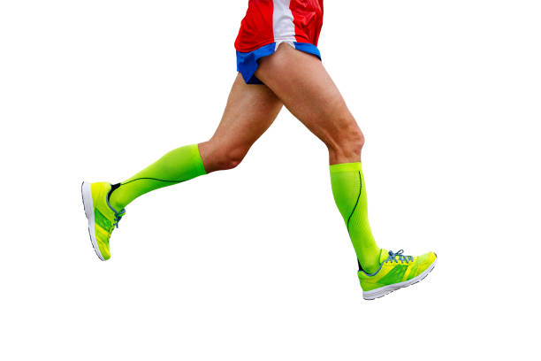 legs runner athlete running marathon in green compression socks isolated on white background