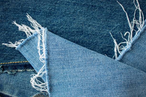 Blue  jeans texture or denim background with seam and thread, textile material