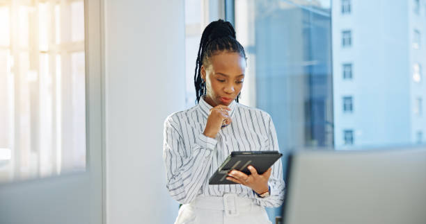 istock Internet, tablet and a business woman in office for communication, creative idea or chat. African entrepreneur person with technology for networking, online planning or email and social media app 1952068445