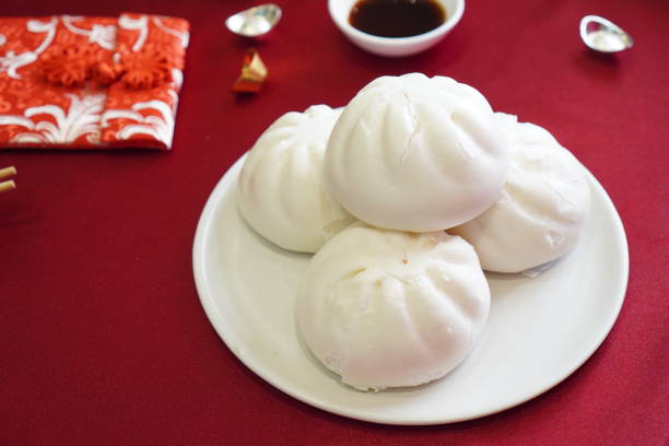 istock Steamed stuff bun in white dish on red color textile 1952079779