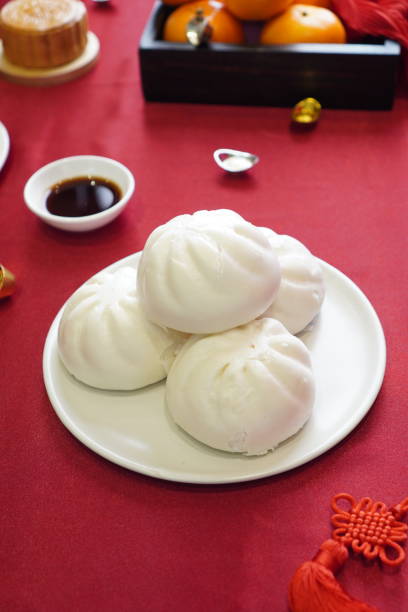 istock Steamed stuff bun in white dish on red color textile 1952080331