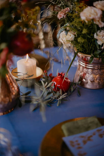 istock bohemian style wedding dining table decorated with a blue covered bronze vase and pomegranate figures. stock photo 1952082465