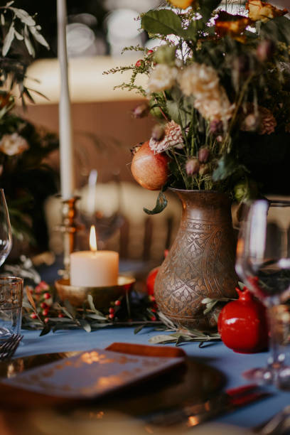 istock bohemian style wedding dining table decorated with a blue covered bronze vase and pomegranate figures. stock photo 1952087292