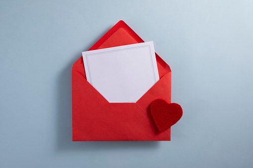 Red envelope and empty greeting card for special days on blue background