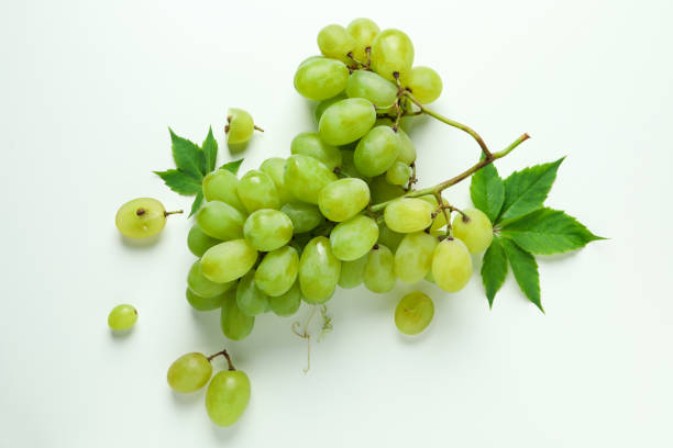 istock Green ripe grape with leaves on white background 1952097391