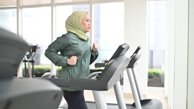 South East Asian woman exercising in the gym. Cardio training on the treadmill in the gym