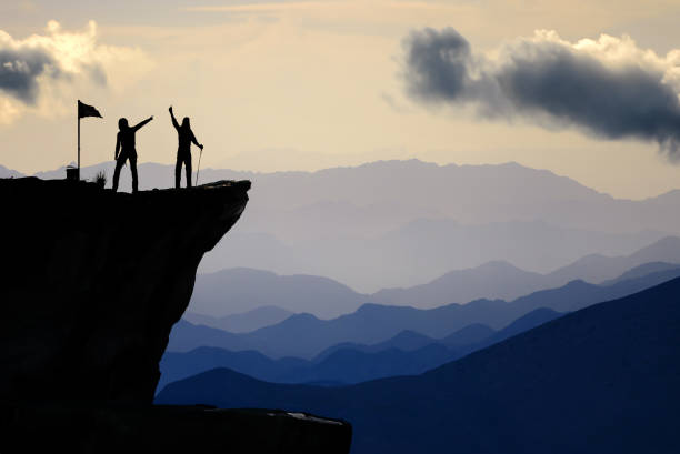 istock The couple who achieved victory write their memories in the summit notebook and display a pose of happiness 1952101250