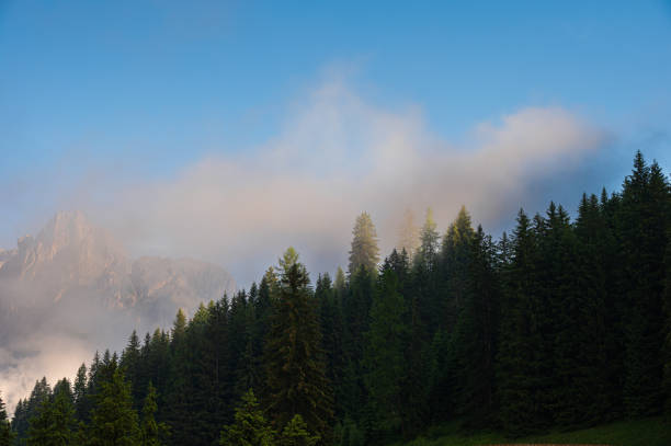 Mount Catinaccio range covered by clouds seen by Pozza di Fassa, Val di Fassa, Dolomites