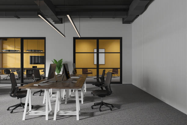 istock Stylish office interior with meeting room and coworking space with pc desktop 1952103629