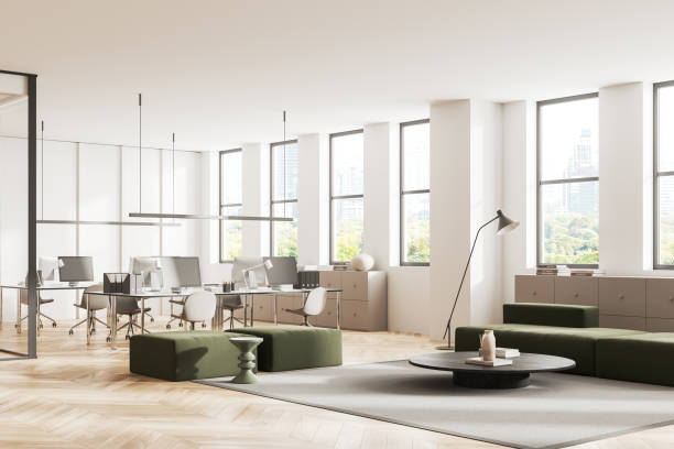 istock Stylish office interior with pc desktop and lounge zone, panoramic window 1952104564