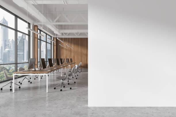 istock White office workspace interior with pc desktop in row, window and mock up wall 1952106659