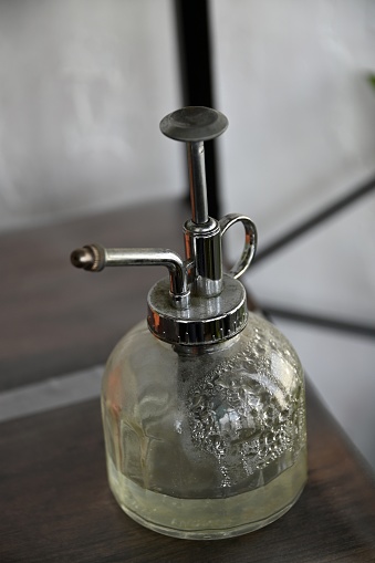Glass and steel garden spray bottle close-up