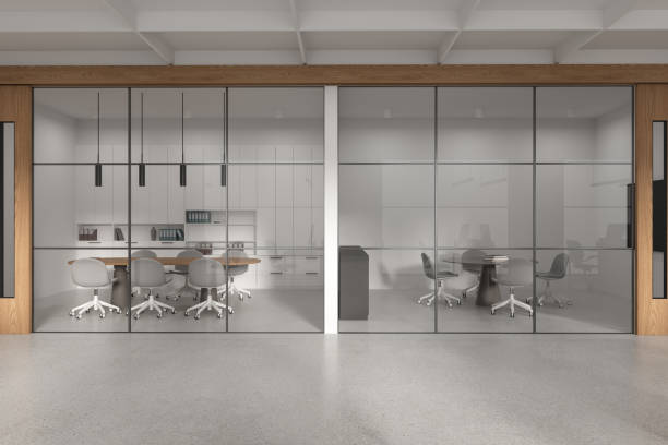 istock Modern glass negotiation room interior with table, chairs and decoration 1952110924