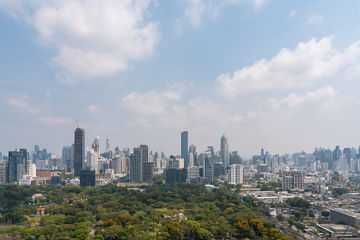 Bangkok panoramic view, skyline with Lumpini park and skyscrapers under cloudy sky. Asian business city center, luxury metropolis and corporate office buildings