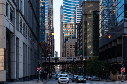 Chicago street with cars and metro moving. Office skyscrapers and business district architecture. Concept of travel and tourism. Illinois, USA, North America