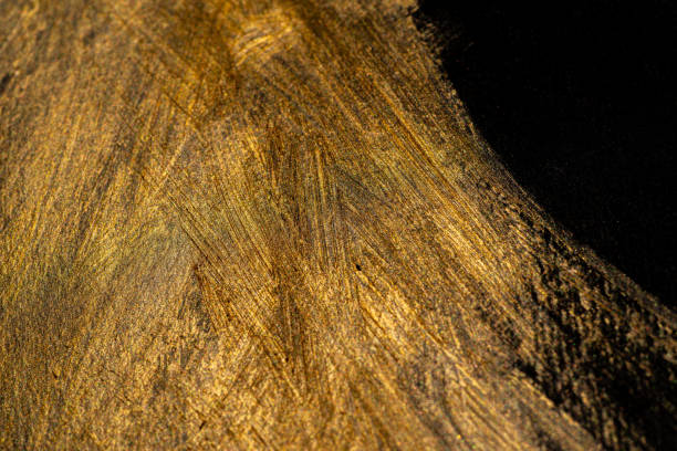 istock golden paint on black background 1952126083