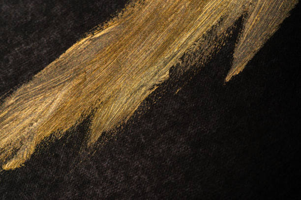 istock golden paint on black background 1952126098