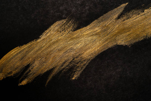 istock golden paint on black background 1952126118