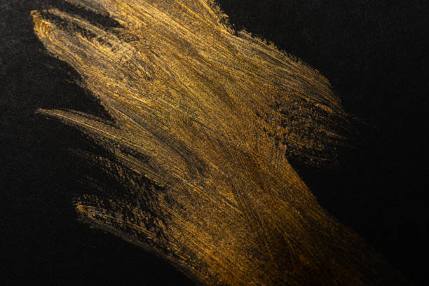 istock golden paint on black background 1952126652