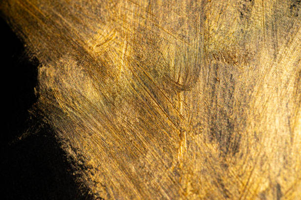 istock golden paint on black background 1952126680