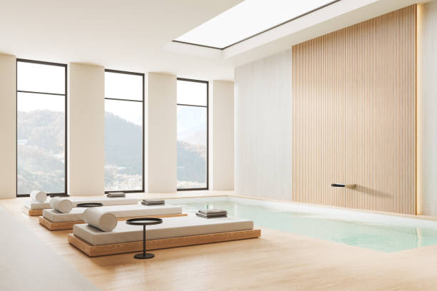 istock White and beige spa interior with loungers and panoramic window 1952129631