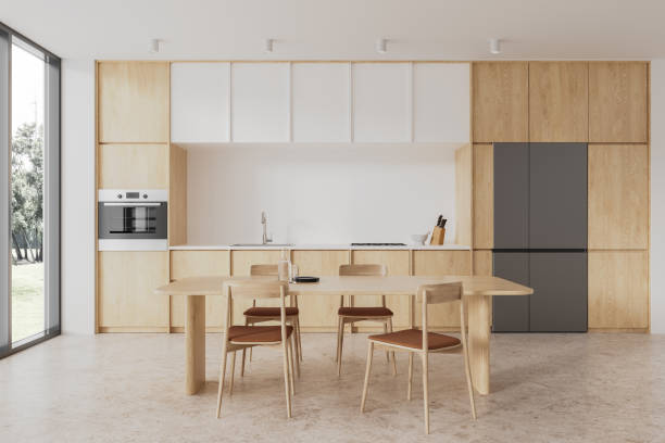 istock Modern home kitchen interior with cooking and eating space, panoramic window 1952135856