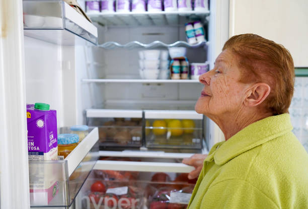 istock Old woman opening the fridge at home 1952136541