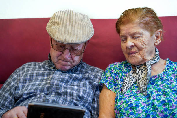 Portrait of a rural senior couple using digital tablet together sitting on the sofa