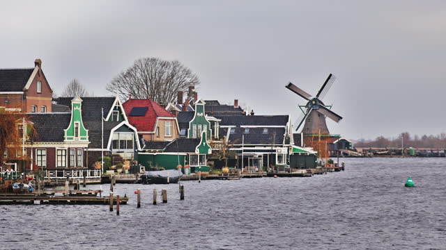 Traditional windmills in Zaanse Schans in the Netherlands, Spinning mills, Rural landscape with windmills in the Netherlands, Ancient wooden windmills in Zaanse Schans, the most popular tourist attraction in the Netherlands