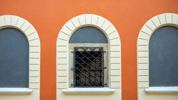 istock Beautiful arched window in building, view from outdoors. Protective bars on the window. 1952157668