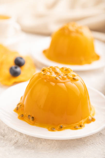 istock Mango and passion fruit jelly with blueberry on gray concrete, side view, selective focus. 1952157979