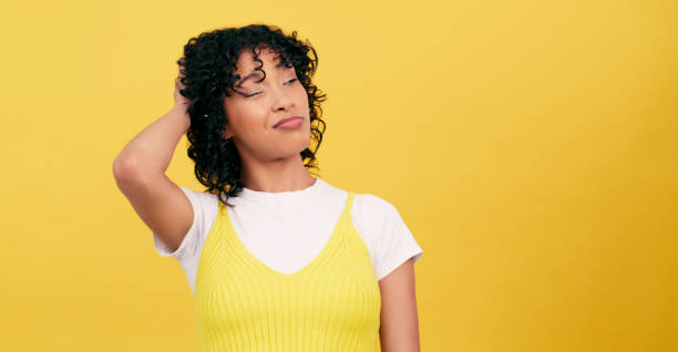 istock Confused, thinking and woman with doubt, scratching head and questions on a yellow studio background. Person, mockup space and girl with emoji, brainstorming and why with problem solving and solution 1952158173