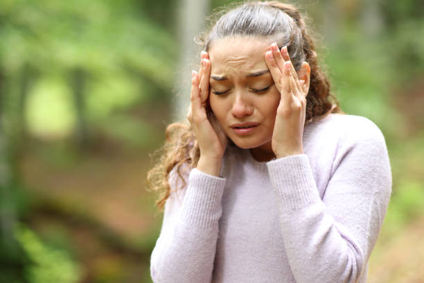 istock Worried woman suffering migraine in a forest 1952169507