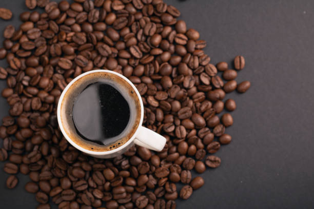 istock espresso, coffee bean, roasted, copy space, drink, cup, caffeine, aroma, cafe, black background, breakfast, beverage, hot drink, fresh, break, view, top 1952171673