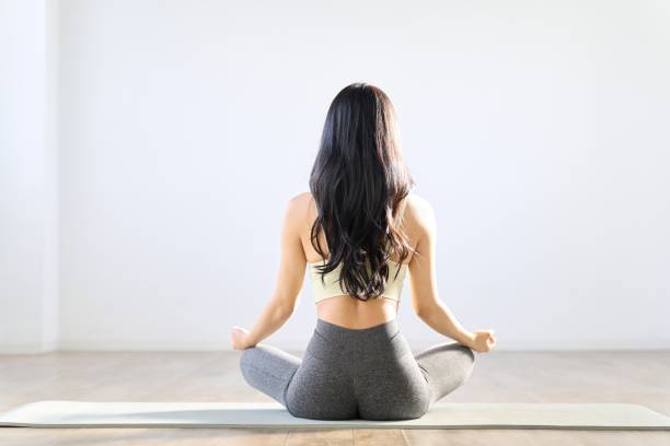 Rear view of a woman meditating