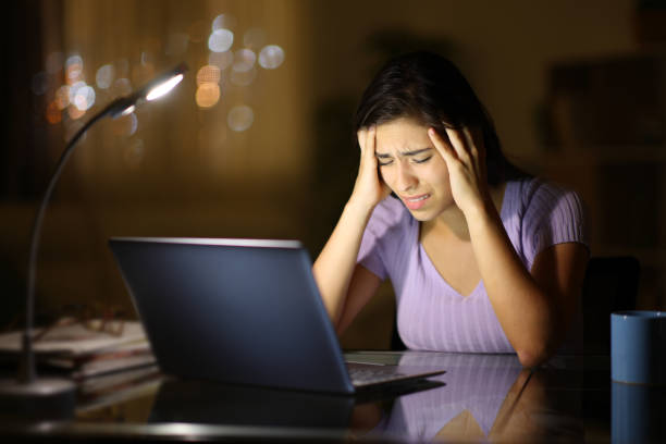 istock Concerned woman with laptop in the night 1952179210