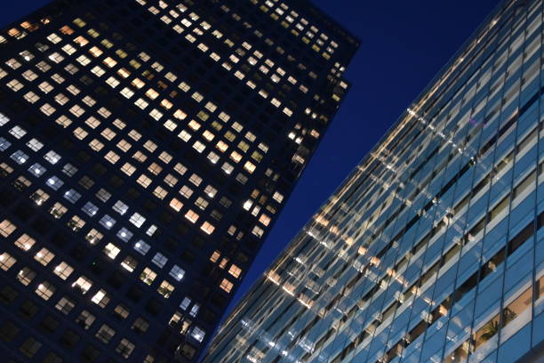 istock London, skyscraper towers lit up at night. Abstract composition 1952204948