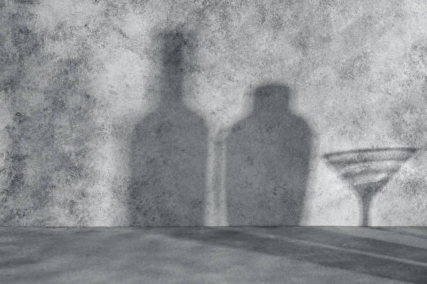 istock Shadow on a gray concrete wall from a bottle, shaker and martini glass. Abstract background with shadows. 1952213774