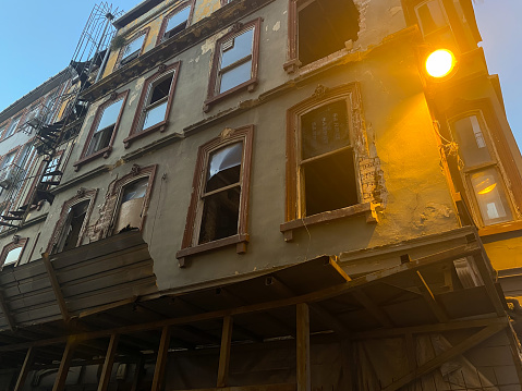 An old building about to be demolished accompanied by a street lamp on the narrow street of Istiklal in the evening. Taksim, Istanbul, Turkey