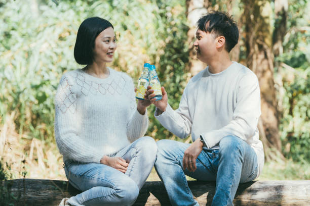 istock Beautiful couple sitting on a rustic log 1952222818