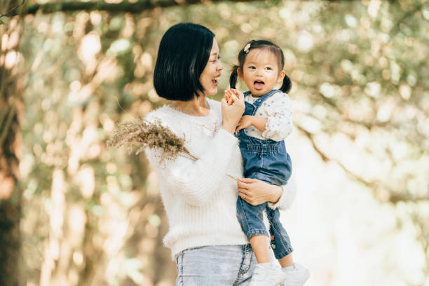 istock Mother hugging daughter outdoors on sunny day 1952222820