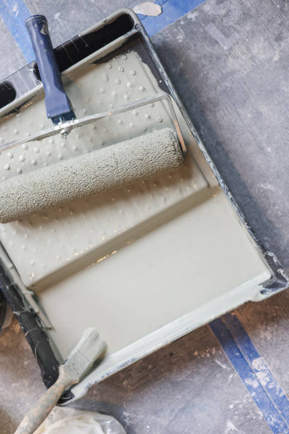 istock Paint roller and brush on a paint tray, ready for some home decorating and home improvement 1952227498